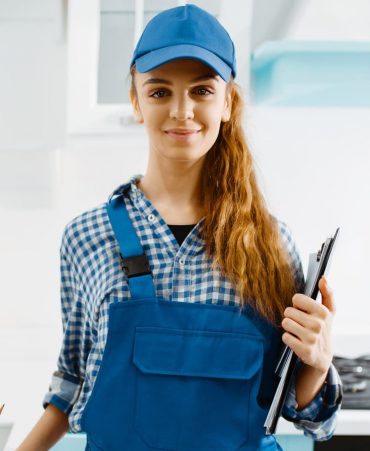 2-female-furniture-maker-in-uniform-holds-notebook-Y9E4CSS.jpg